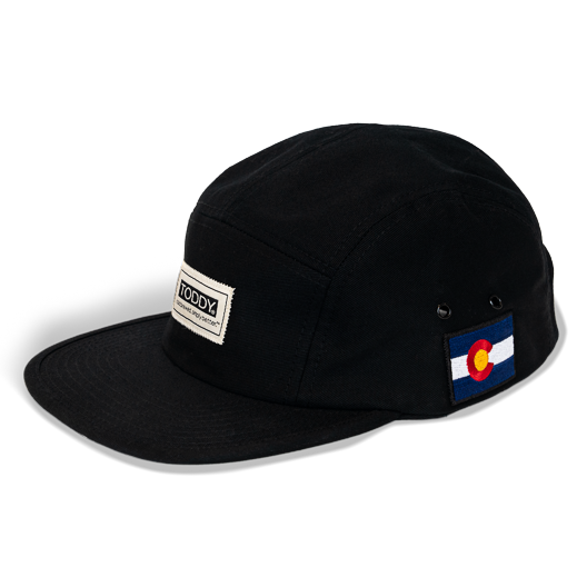 Toddy branded 5 panel hat from the left side on a white background