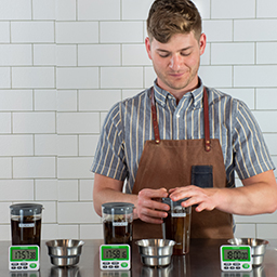 Barista using the 3-brewer Toddy Cold Brew Cupping Kit
